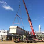 Lifting very large heat exchanger with crane.