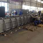 Constructing very large shell and titanium tube heat exchangers with Monel cladding.